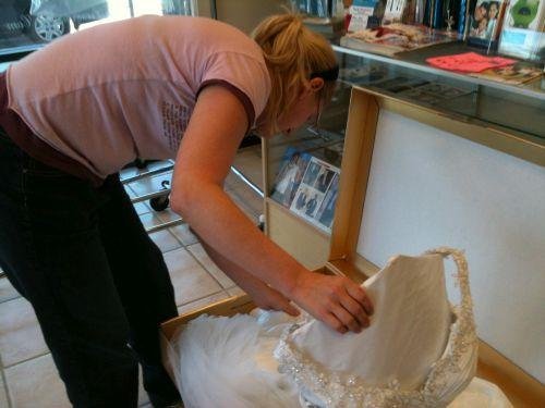 Bride inspecting Wedding Gown in Golden Box