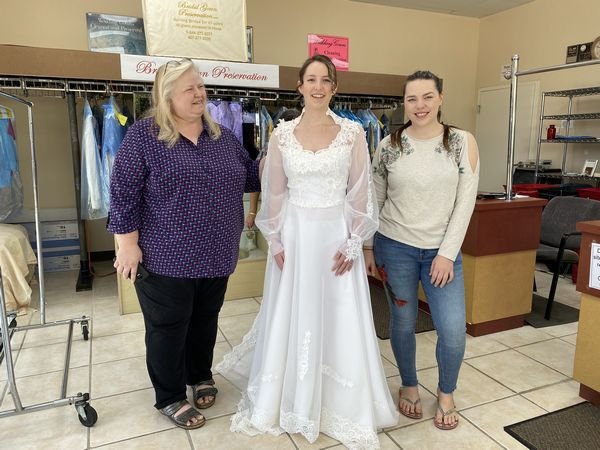 Wedding Gown restoration 35 year old;Bride happy and excited to wear the restored wedding gown; 