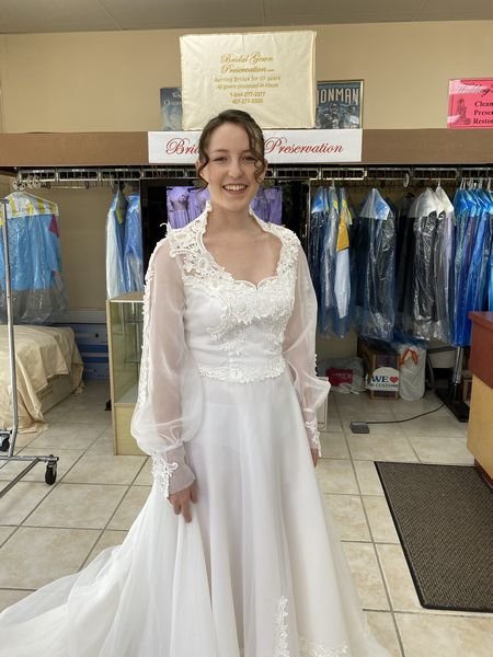 Wedding Gown restoration 35 year old;Bride happy and excited to wear the restored wedding gown; 